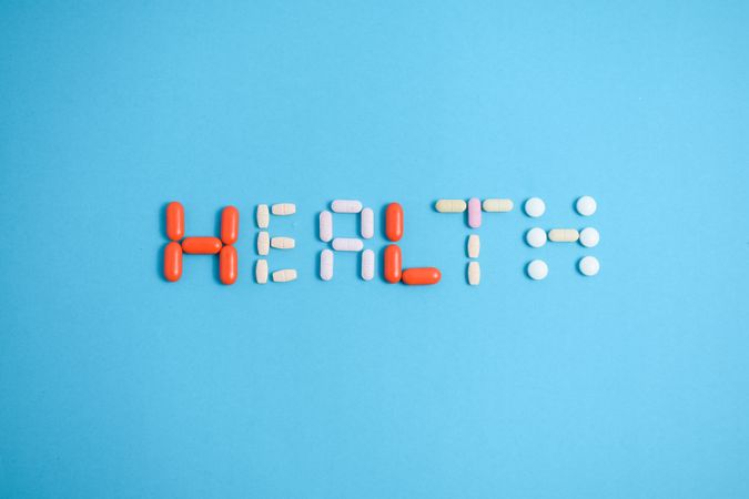 Multiple pills spelling the word "HEALTH"