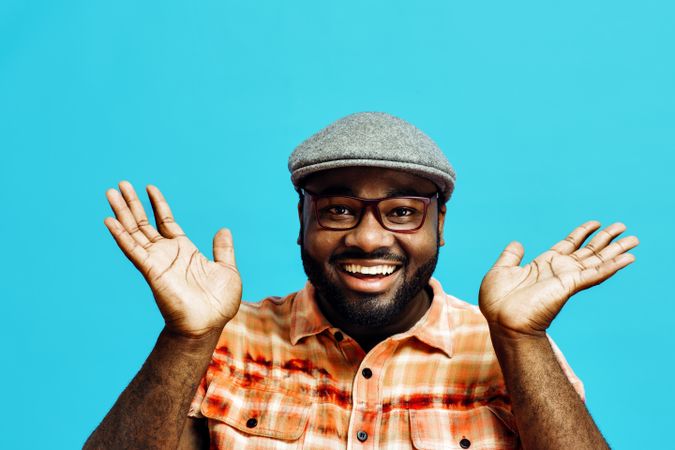 Happy man with hands next to face