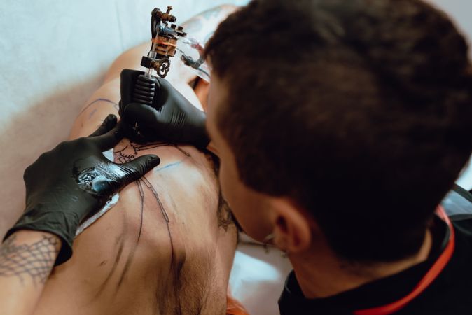 Stylish male drawing tattoo