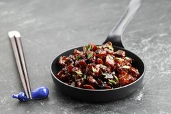 Delicious Japanese chicken dish served with chopsticks
