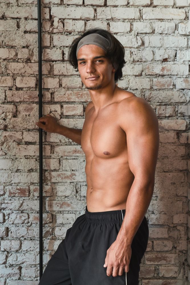 Muscular man posing in gym