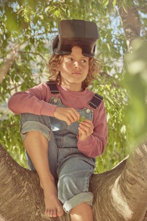 Cute boy with VR on sunny day