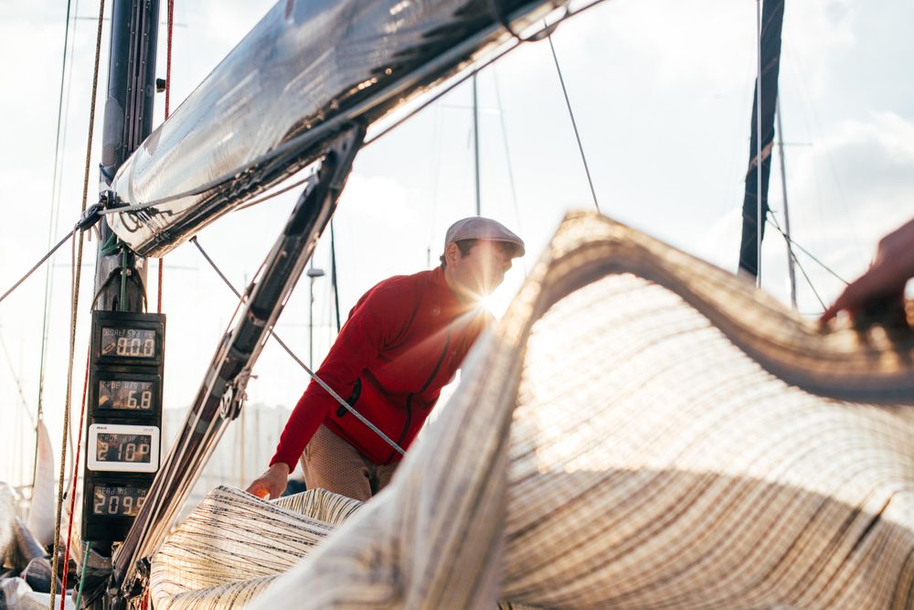 Sailor on yacht arranging the covering