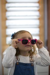 Young girl trying on glasses