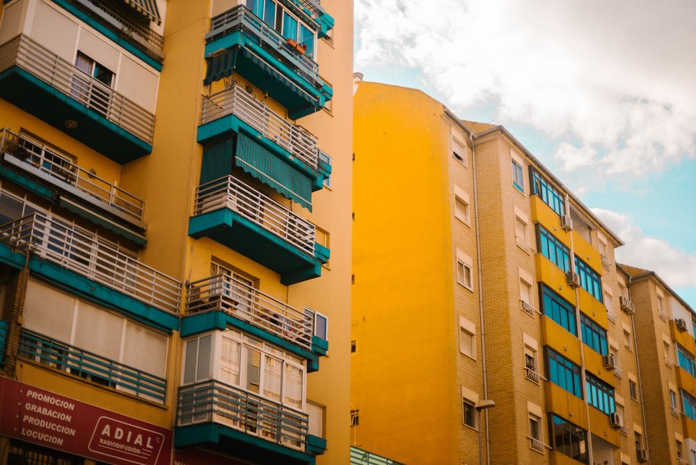 Cloudy sky over yellow apartment building