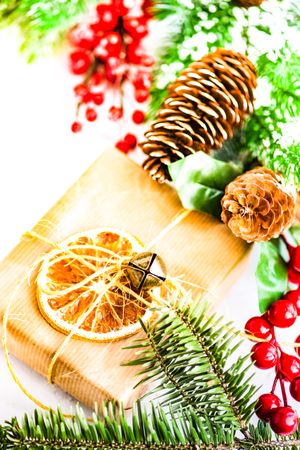 Bright Christmas table with gift and dried orange