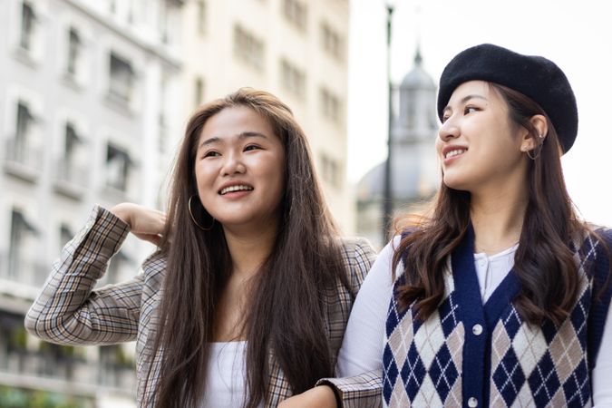 Asian female friends walking on the street in the city