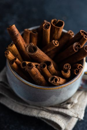 Side view of cinnamon sticks in large mug