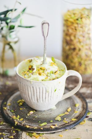 Cup of pistachio ice cream with spoon