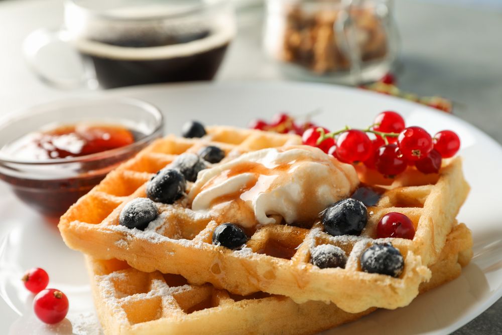 Composition of breakfast with belgian waffles, space for text