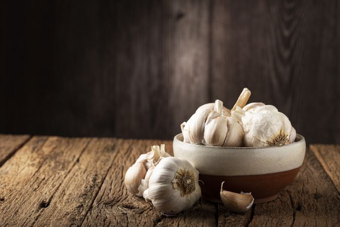 Garlic bulb and garlic cloves on the wooden table.