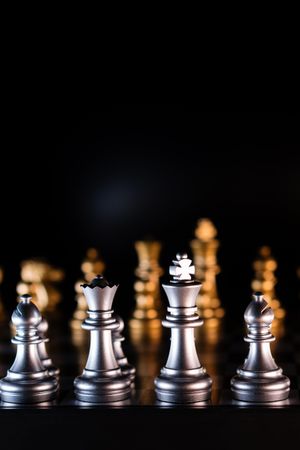 Silver chess pieces with golden backlight