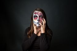 Young woman with creepy face paint