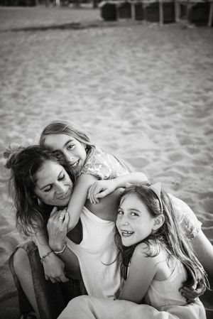 Playing woman with kids on beach