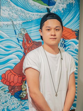 Asian male standing on canvas background