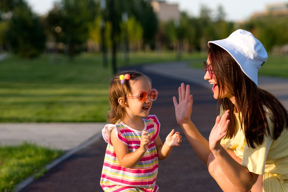 Toddler girl and mom playing outside