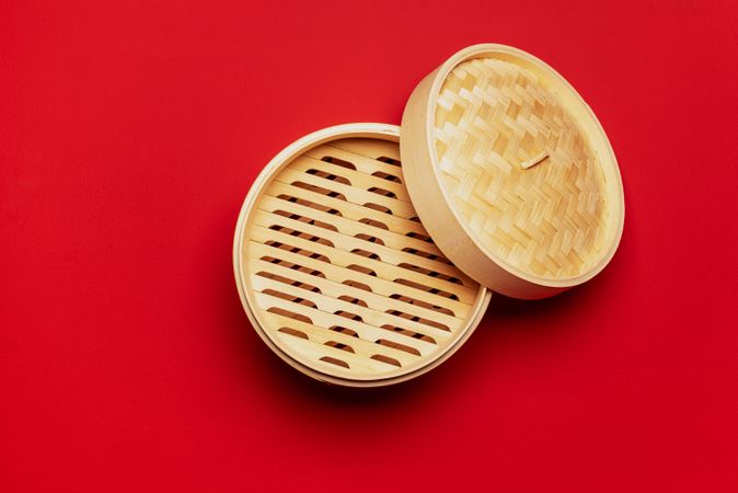 Bamboo steamer above view, isolated on a red background