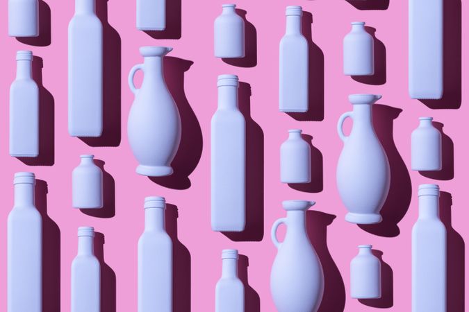 Painted glass bottles on pink background