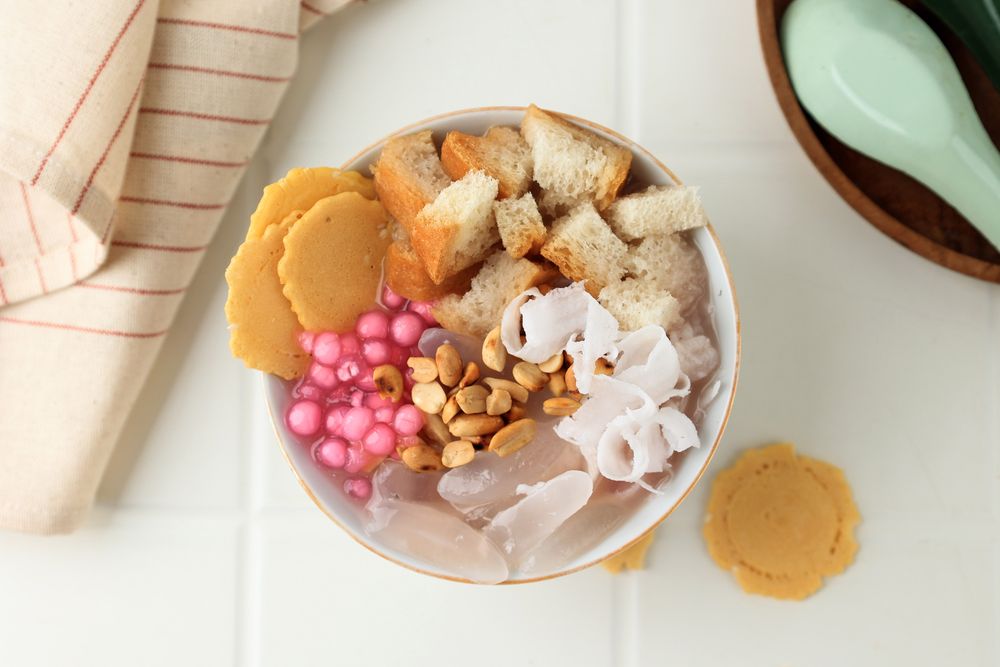 Wedang Sekoteng, Traditional Warm Dessert from Java, Indonesia. Red Ginger Tea with Peanuts, Sago Pearl, Coconut, Palm Fruit, and Bread