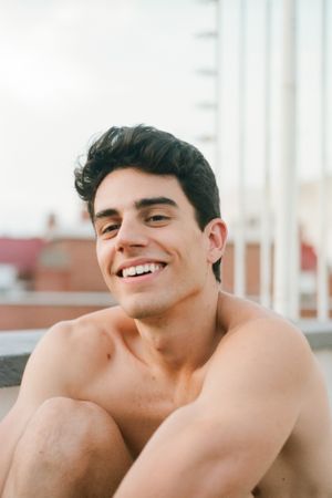 Face of shirtless young man smiling