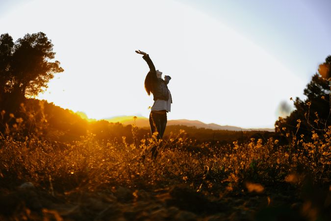 Woman walking on meadow and enjoying freedom