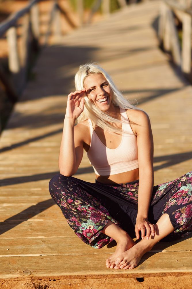 Woman relaxing on wooden bridge