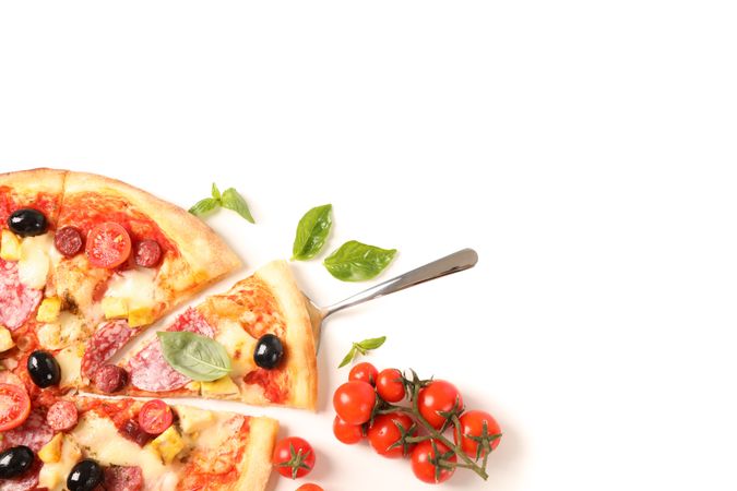 Pizza, basil, tomatoes and shovel isolated on blank background