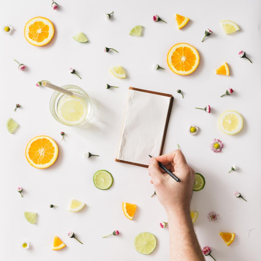 Colorful pattern made of orange, lemon, lime and flowers with hand writing on old notebook