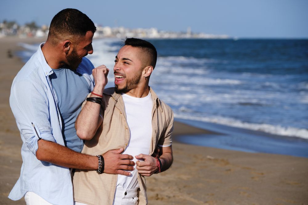 Gay couple walking on beach