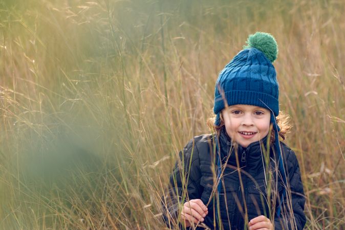 Content boy standing in grass