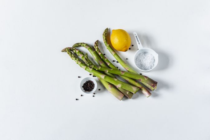 Asparagus with salt and pepper in small dishes