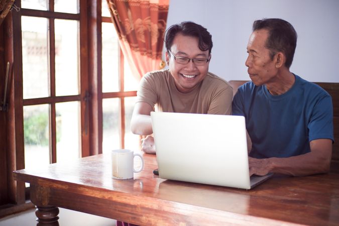 Father and son with laptop
