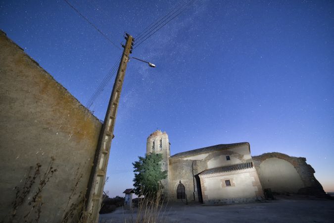 Aged cathedral in suburbs under starry sky