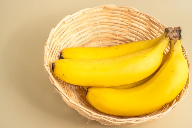 The bananas in a basket on a table