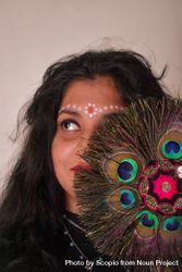 Portrait of Indian woman with Tilaka on forehead beside peacock feather bY7jN5
