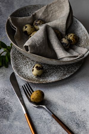 Easter card concept with elegant grey ceramic bowl and speckled eggs