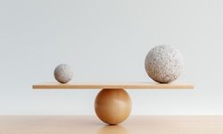 Spheres being balanced on wooden scale