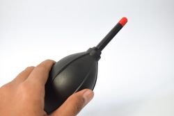Hand holding blower for lenses