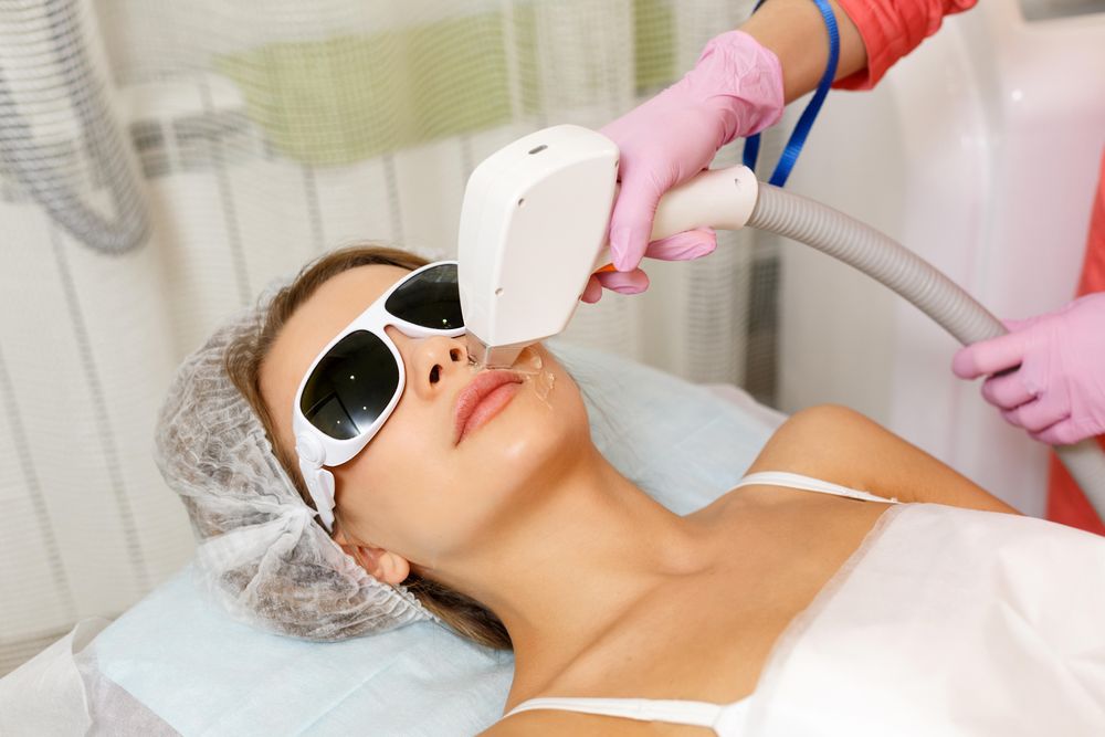 Female face with laser hair tool on upper lip