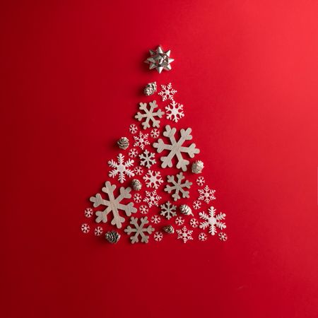 Christmas Tree made of snowflakes on red background