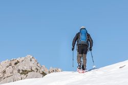 Anonymous skiing in mountainous terrain in winter