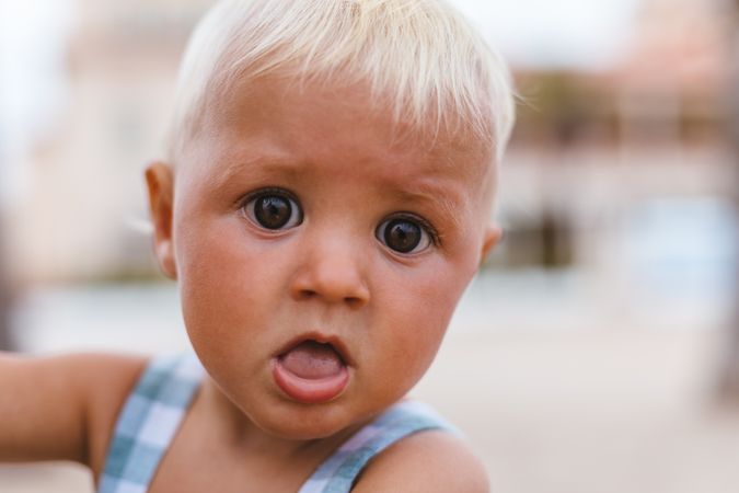 Portrait of a blonde baby boy on the beach