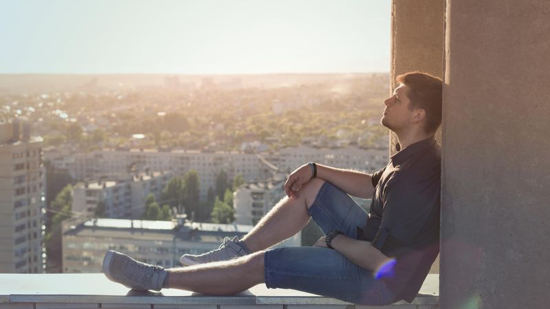 Man sitting and relaxing atop roof