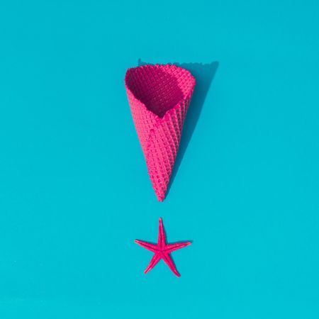 Starfish with pink waffle cone on bright blue background