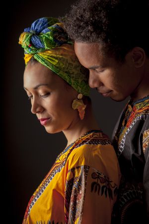 Couple of young Black people standing embracing