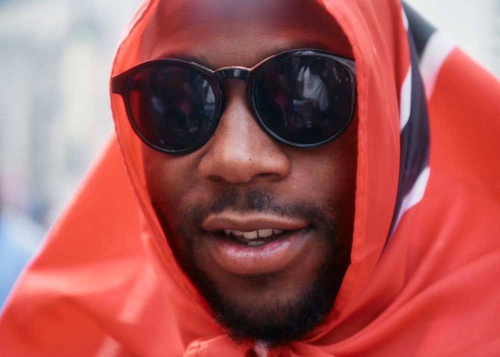 London, England, United Kingdom - August 28, 2022: Man wrapped in Trinidad & Tobago flag
