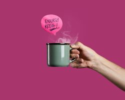 Hand holding a steaming coffee mug with "Energy Refill!" message on a pink background.