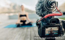 Female content creator recording yoga video for blog post 0vq7gb