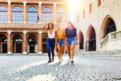 Happy multiracial women having fun together on summer vacation in Italy