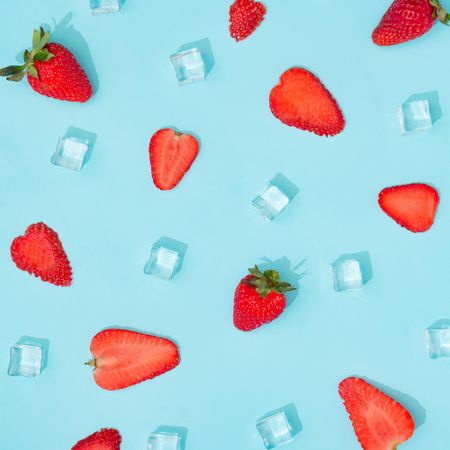 Creative summer background composition with strawberries and ice cubes